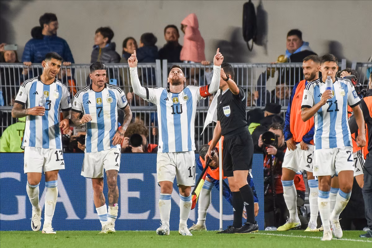 Lionel Messi celebrates with Cristian Romero