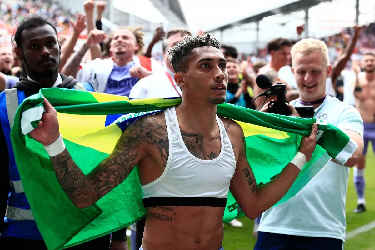 Raphinha pictured celebrating with Leeds United fans.