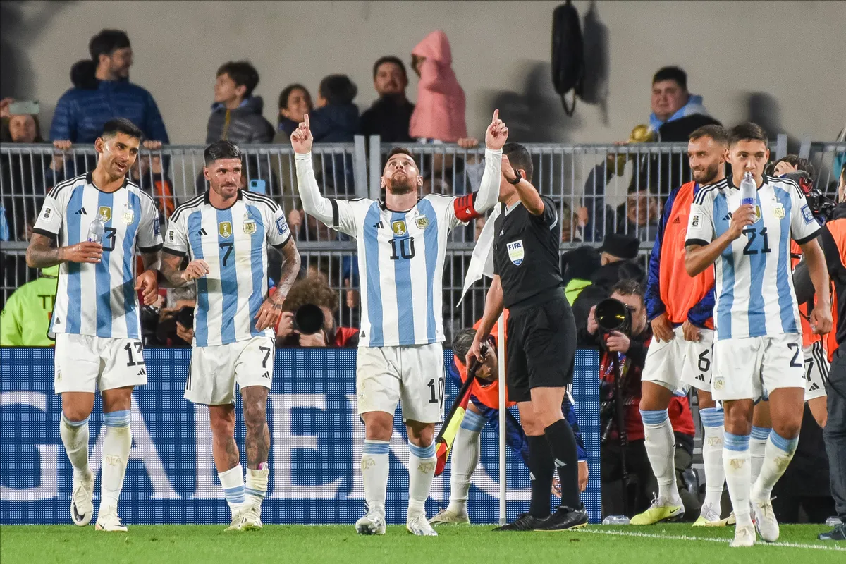 Lionel Messi celebrates with Cristian Romero