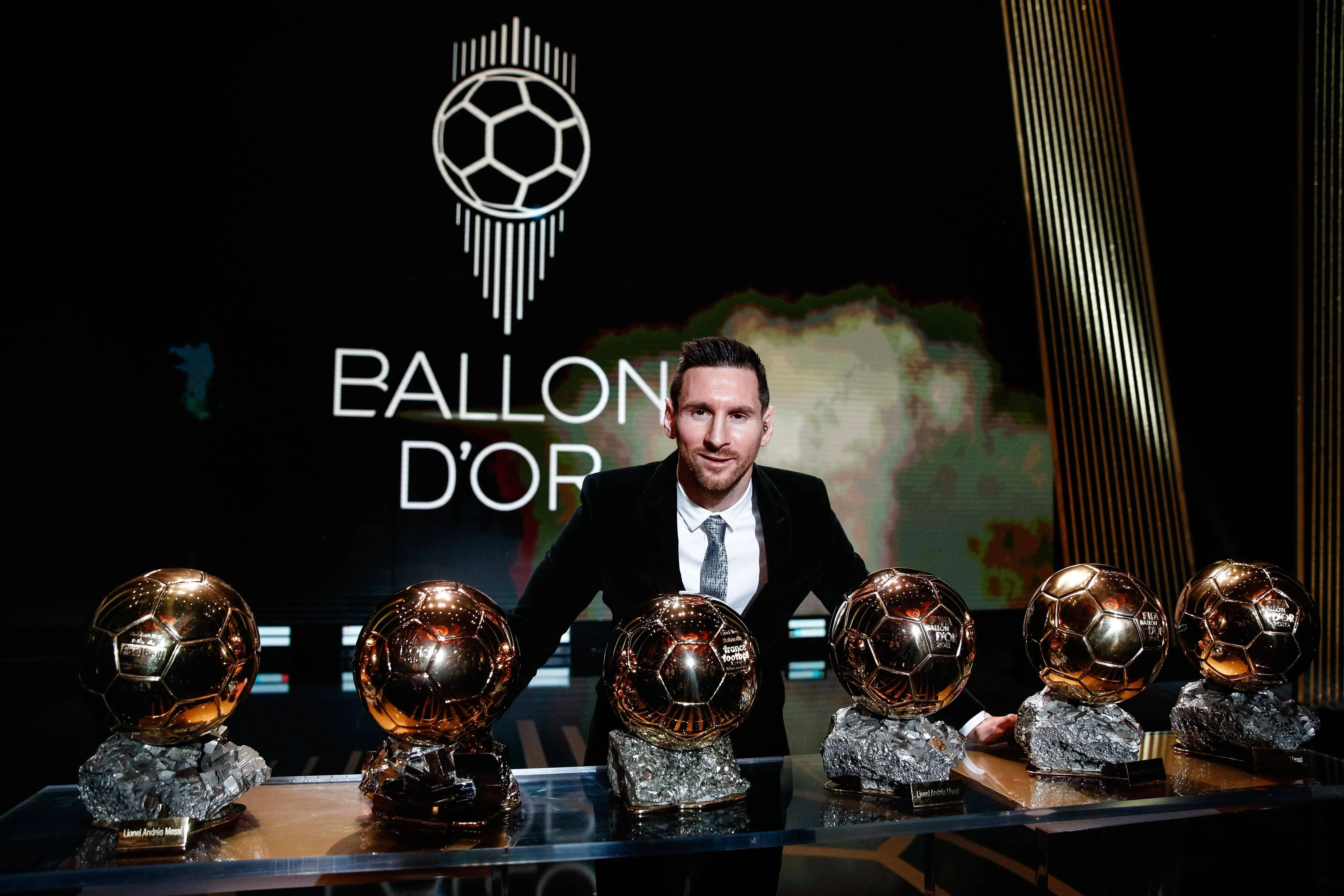 Lionel Messi with his Ballon d'Or trophies