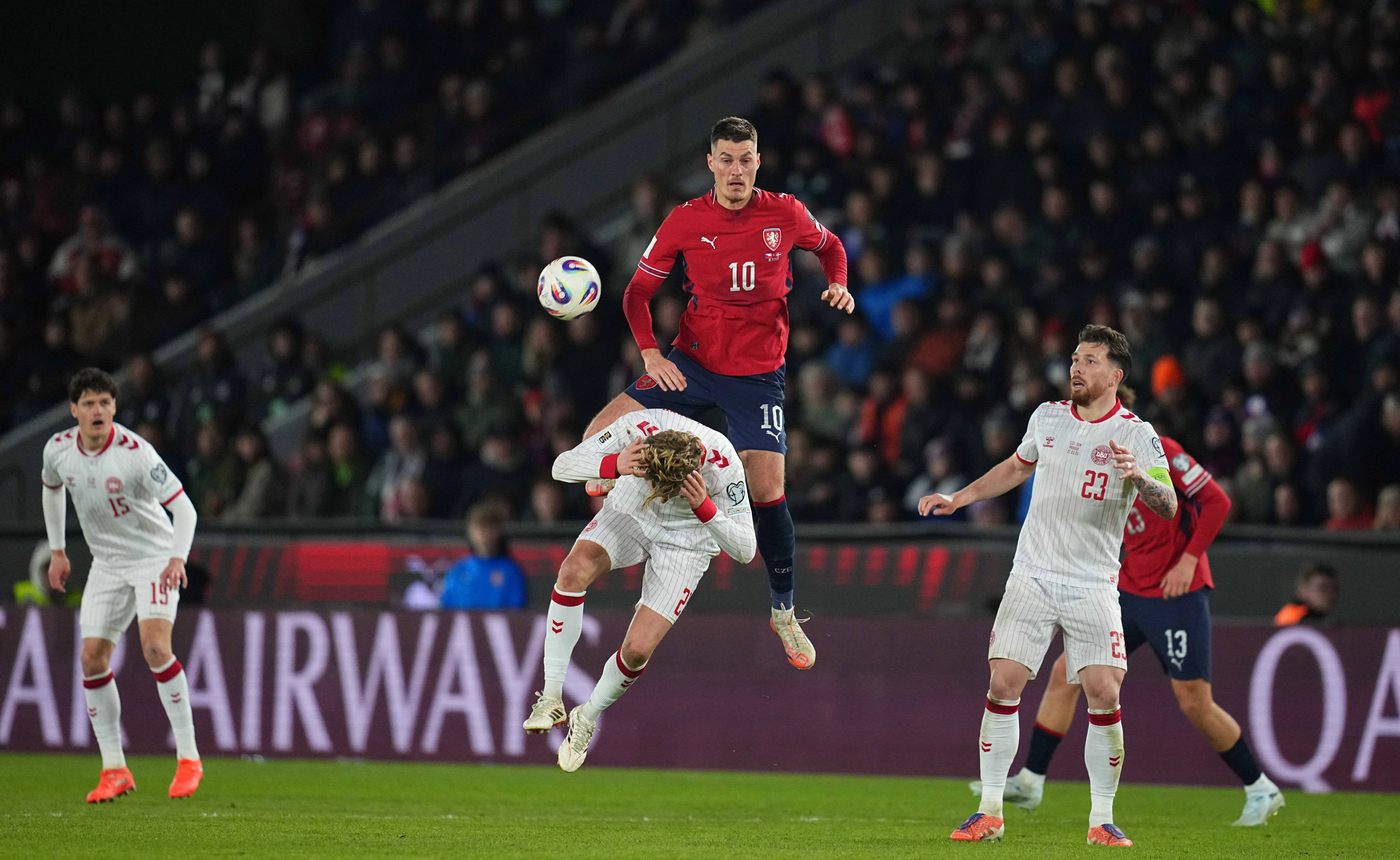 Czechia striker Patrik Schick rises above the Denmark defence