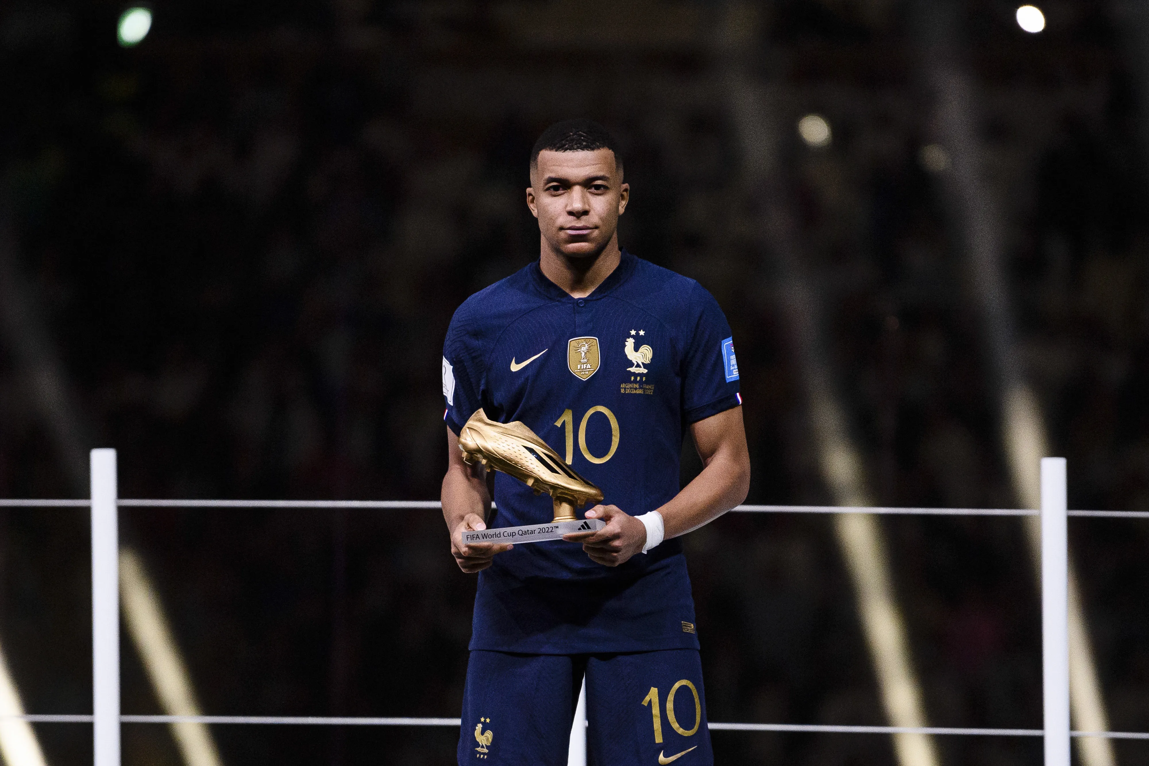 Kylian Mbappe with the Golden Boot trophy at the 2022 World Cup final